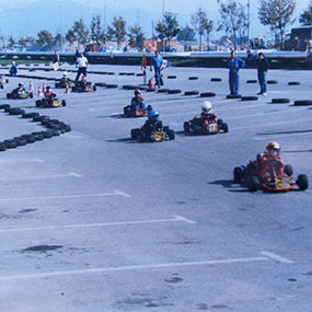 Go-karts racing on a circuit marked out with tyre barriers