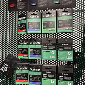 Sinter brake pad packs hanging on a pegboard display