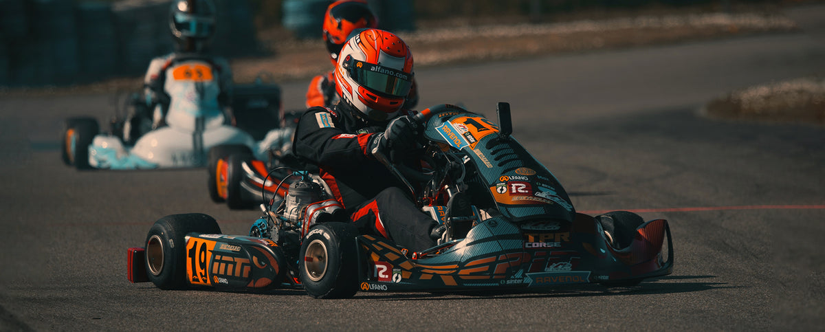 Professional kart racer number 19 with Sinter sponsorship competing on track
