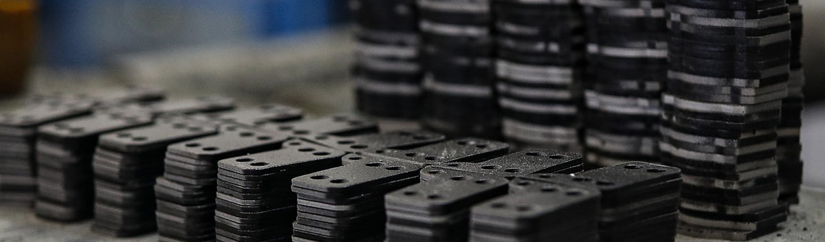 Stacks of precision-cut brake pad backing plates in Sinter factory