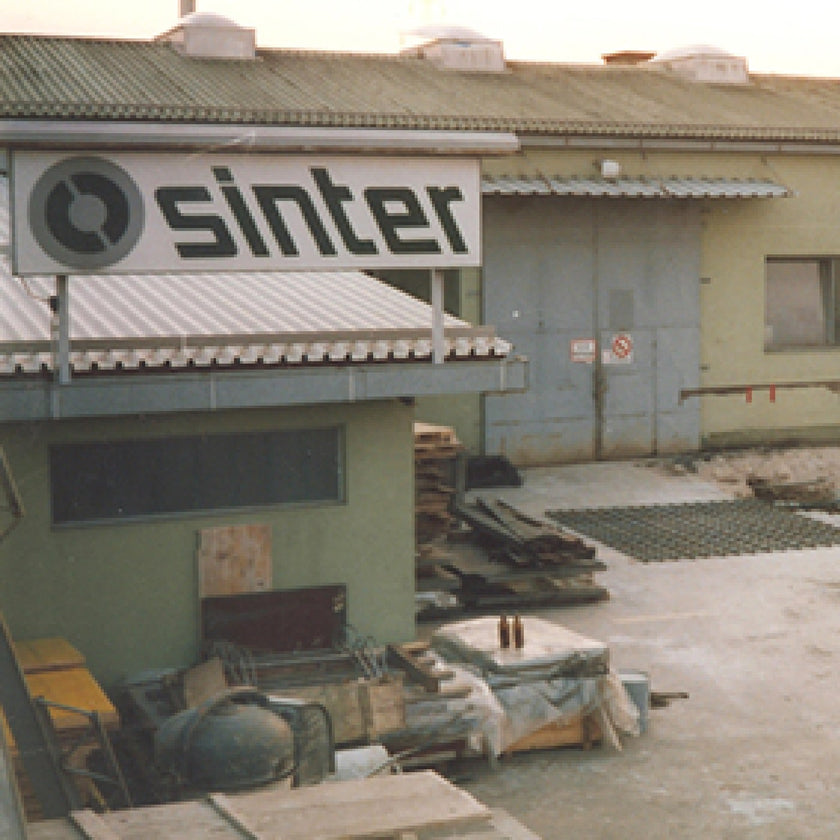The Sinter sign above an early factory building