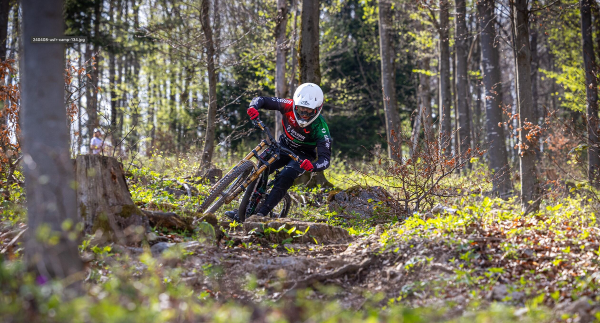 A Unior Sinter Factory Racing rider cornering on a forest trail