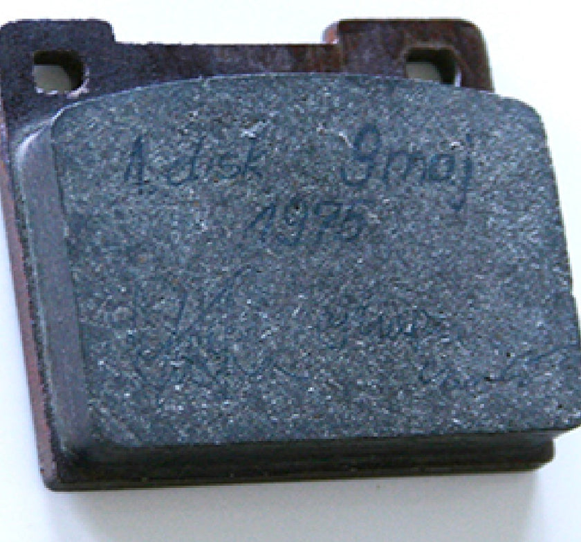 An early disc brake pad with handwriting on its friction surface